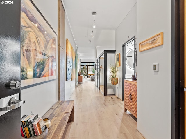 hall featuring light hardwood / wood-style floors and rail lighting