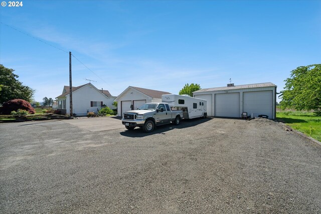 view of front facade with a garage and an outbuilding