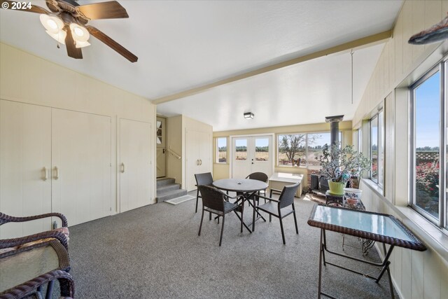 sunroom / solarium featuring lofted ceiling, ceiling fan, and plenty of natural light