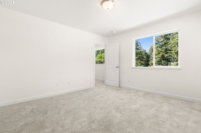 unfurnished room with light carpet