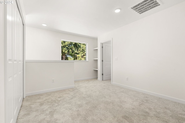 carpeted empty room featuring built in features