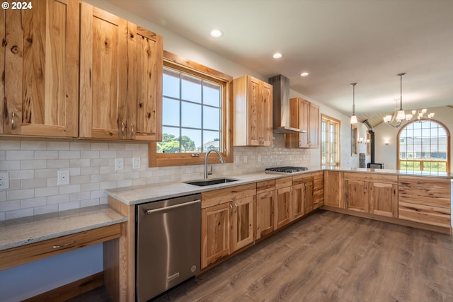 kitchen with wall chimney exhaust hood, stainless steel appliances, sink, a notable chandelier, and dark hardwood / wood-style floors