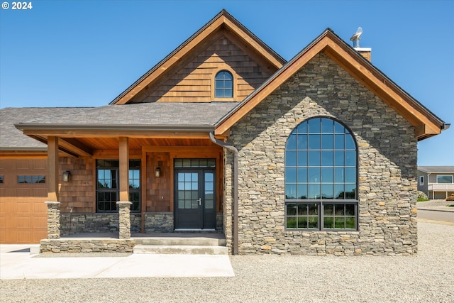 view of front facade featuring covered porch and a garage