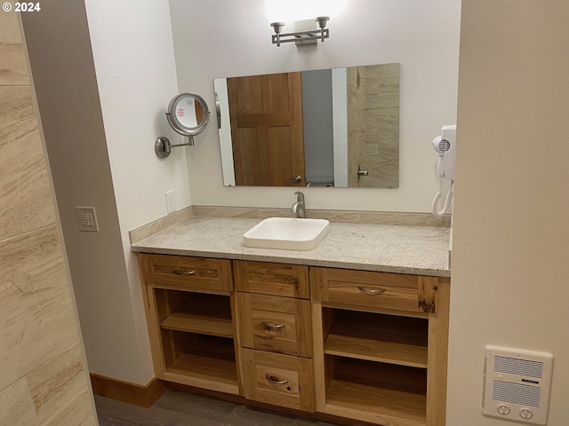 bathroom with vanity and hardwood / wood-style flooring