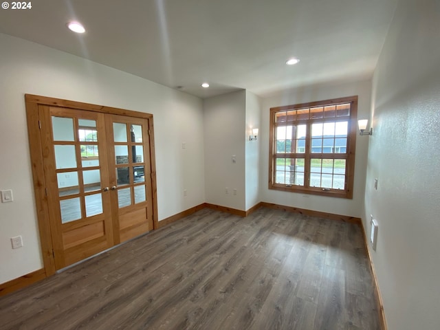 unfurnished room with dark hardwood / wood-style floors and french doors