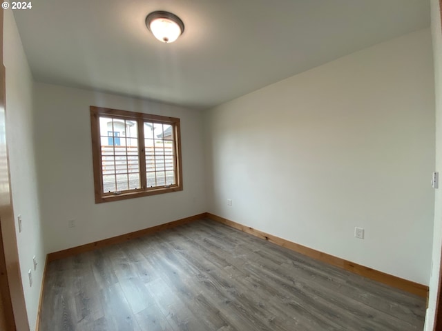 unfurnished room featuring dark wood-type flooring