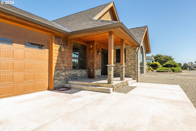 view of front of home featuring covered porch and a garage