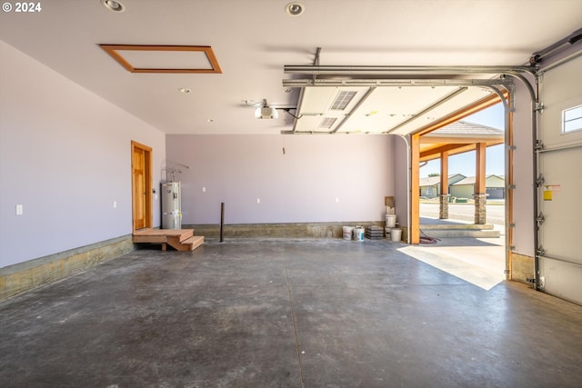 garage with secured water heater and a garage door opener