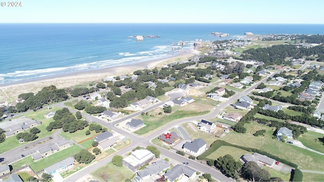 birds eye view of property featuring a water view and a beach view