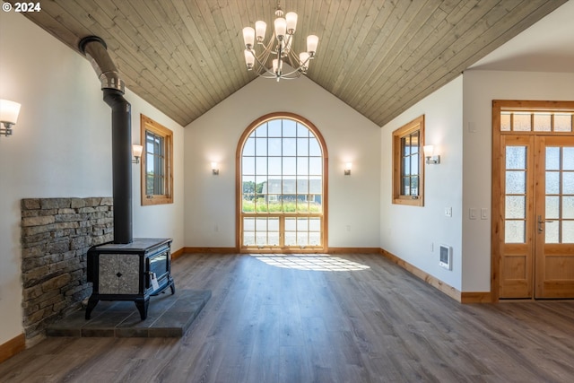 unfurnished living room featuring a wood stove, wooden ceiling, an inviting chandelier, dark hardwood / wood-style flooring, and lofted ceiling