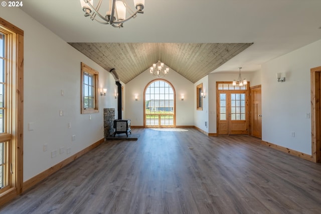 unfurnished living room featuring vaulted ceiling, a wood stove, and dark wood-type flooring