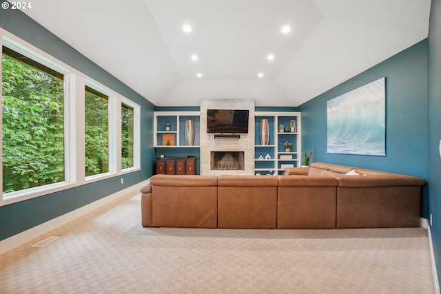 unfurnished living room featuring light colored carpet, a fireplace, and vaulted ceiling