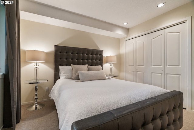 bedroom featuring carpet and a closet