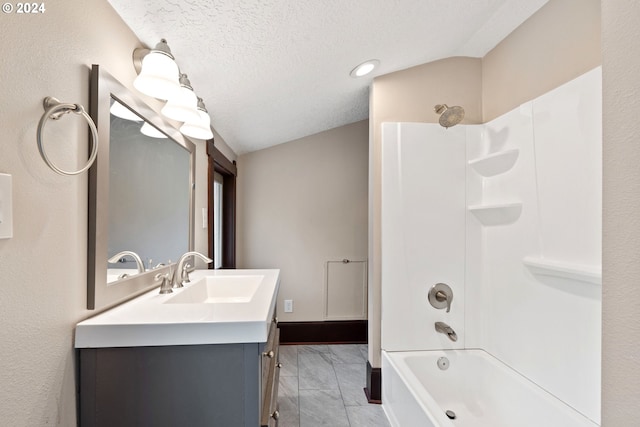 bathroom with vanity, tile patterned flooring, bathtub / shower combination, and a textured ceiling