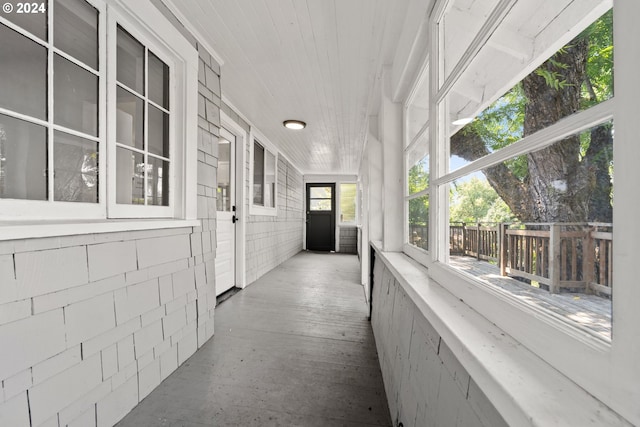 unfurnished sunroom with wooden ceiling