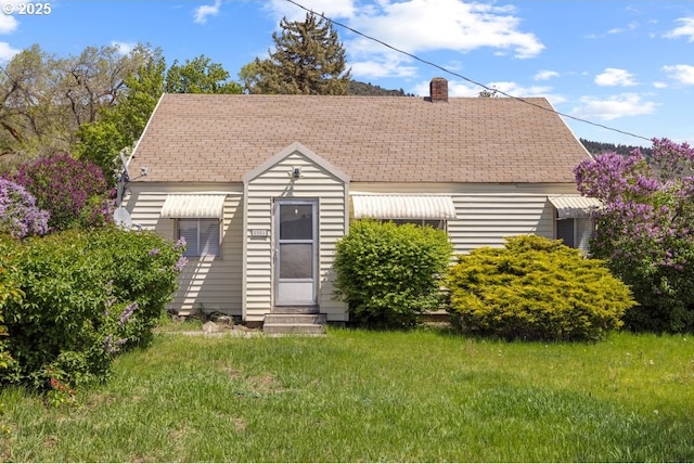 5851 Wocus Rd, Klamath Falls, OR 97601 - view of front of home with entry steps, a shingled roof, a front lawn, and a chimney