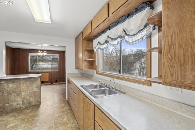 kitchen featuring hanging light fixtures, a wealth of natural light, a notable chandelier, and sink