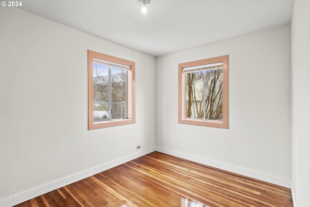 unfurnished room featuring hardwood / wood-style floors