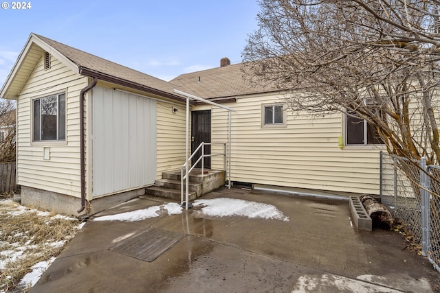 snow covered house with a patio