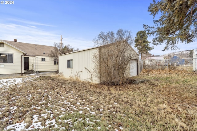 rear view of property featuring a garage