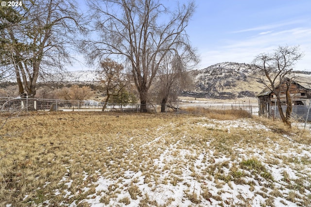 view of yard with a mountain view and a rural view