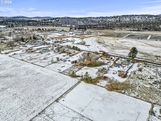 snowy aerial view featuring a mountain view