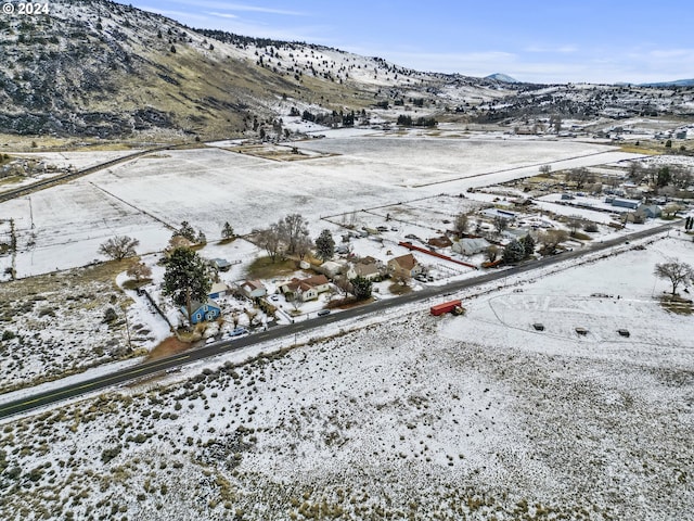 snowy aerial view with a mountain view