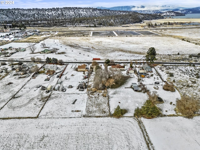 snowy aerial view featuring a mountain view