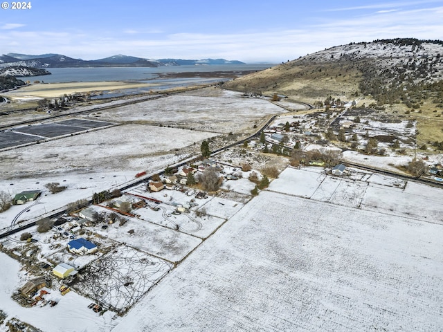 snowy aerial view featuring a mountain view