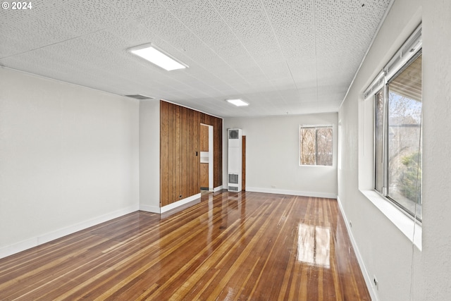 5851 Wocus Rd, Klamath Falls, OR 97601 - spare room with hardwood / wood-style flooring, baseboards, and a heating unit