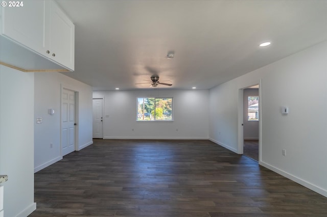 unfurnished room with dark hardwood / wood-style flooring, plenty of natural light, and ceiling fan