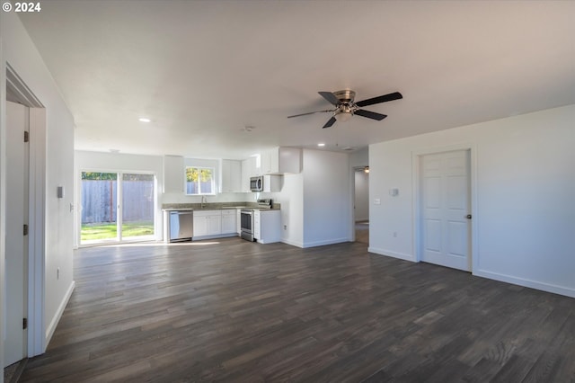 unfurnished living room with ceiling fan and dark hardwood / wood-style flooring