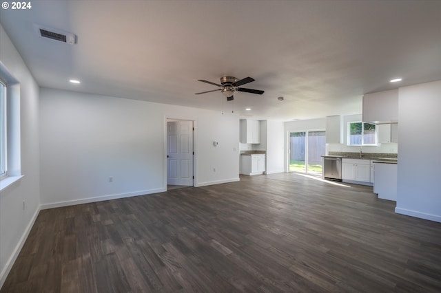 unfurnished living room with ceiling fan and dark hardwood / wood-style flooring