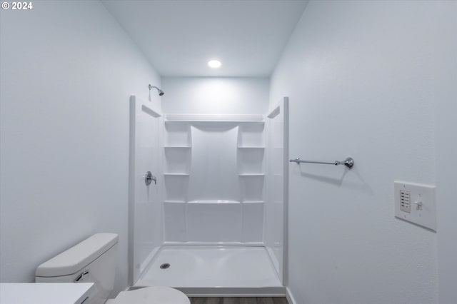 bathroom with vanity, toilet, and walk in shower