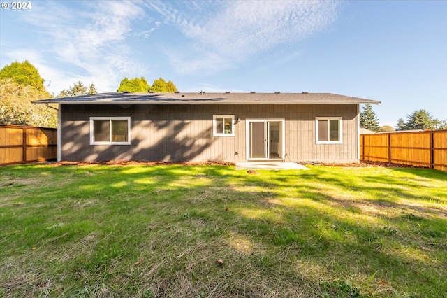 rear view of house with a yard