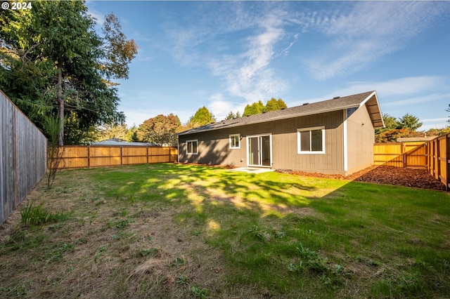 rear view of house with a yard