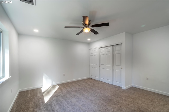 unfurnished bedroom with carpet, recessed lighting, baseboards, a closet, and ceiling fan
