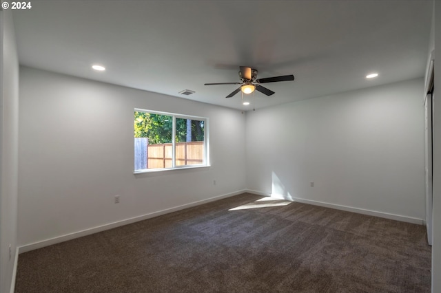 carpeted spare room with ceiling fan