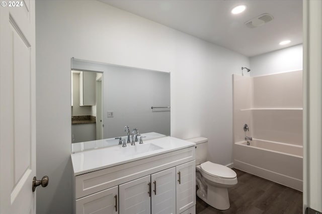 bathroom featuring wood finished floors, toilet, shower / bath combination, vanity, and recessed lighting