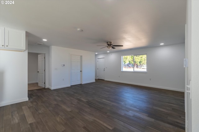 unfurnished living room featuring ceiling fan, recessed lighting, dark wood-style flooring, and baseboards