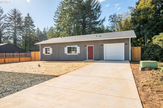 ranch-style house with driveway, fence, and a garage