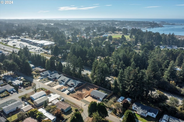 aerial view of property and surrounding area featuring a large body of water