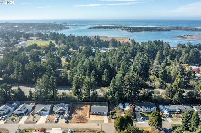 aerial view of property's location with nearby suburban area and a large body of water