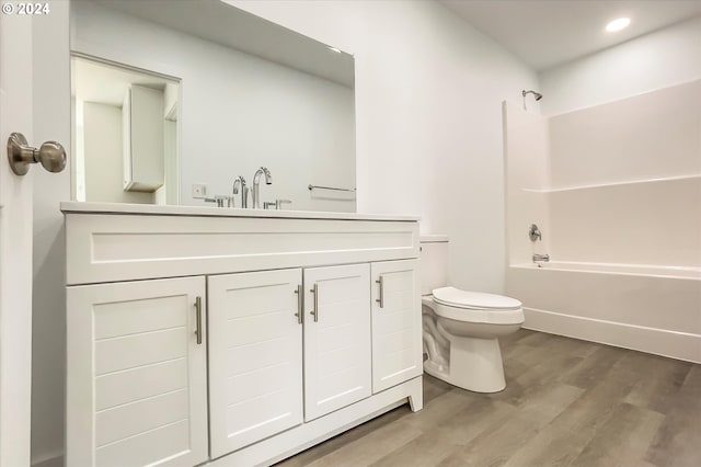 full bathroom featuring wood-type flooring, vanity, toilet, and shower / tub combination