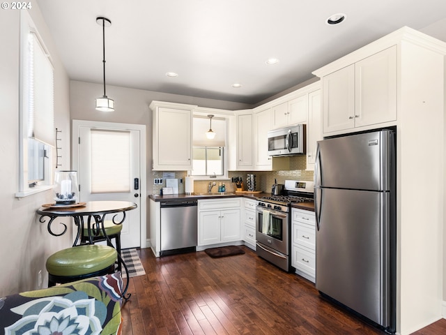 1506 NW Awbrey Rd, Bend, OR 97703 - kitchen with dark wood-type flooring, white cabinets, pendant lighting, stainless steel appliances, and sink
