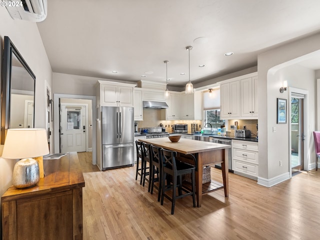 1506 NW Awbrey Rd, Bend, OR 97703 - kitchen featuring white cabinetry, pendant lighting, stainless steel appliances, light hardwood / wood-style flooring, and sink