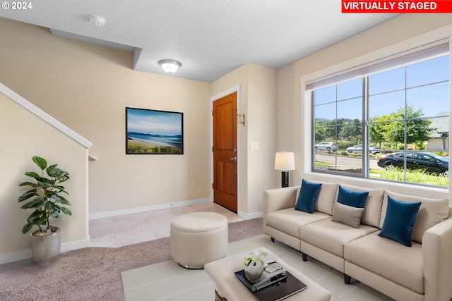 living room featuring light colored carpet and a textured ceiling