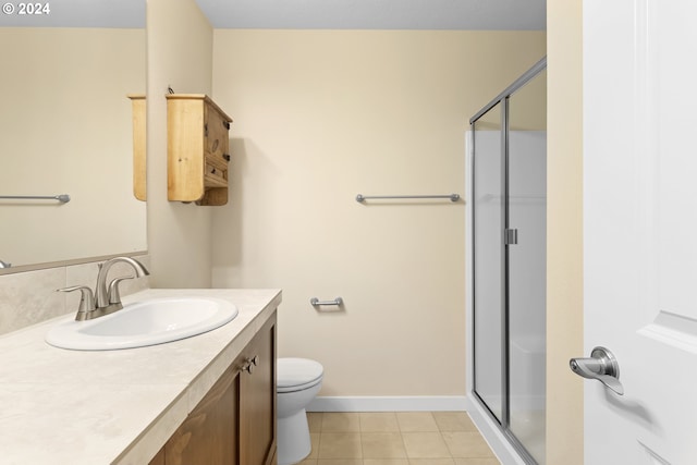 bathroom featuring walk in shower, toilet, vanity, and tile patterned floors