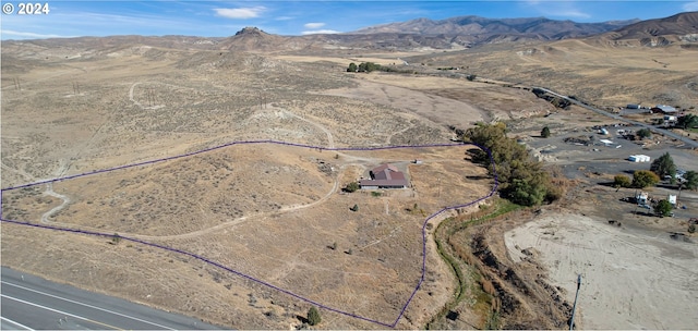 birds eye view of property with a mountain view