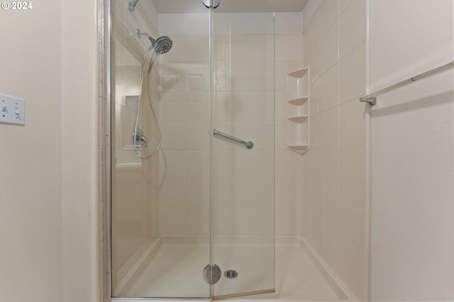 bathroom featuring a shower with door